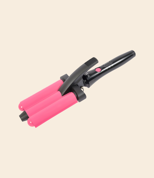soleil beach waver curling iron with pink barrel and black handle, with pink power button and temperature control displays against a light beige background