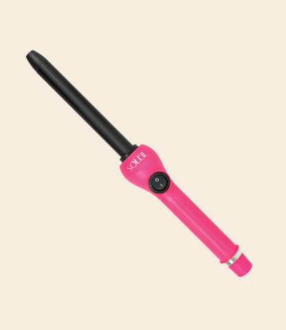 soleil curling iron with one power button, black barrel with 19mm, pink handle and silver details against a light beige background
