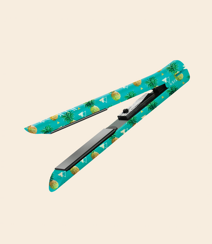 Soleil flat iron with pineapple pattern, black ceramic plates, and on/off button. Set against a beige background