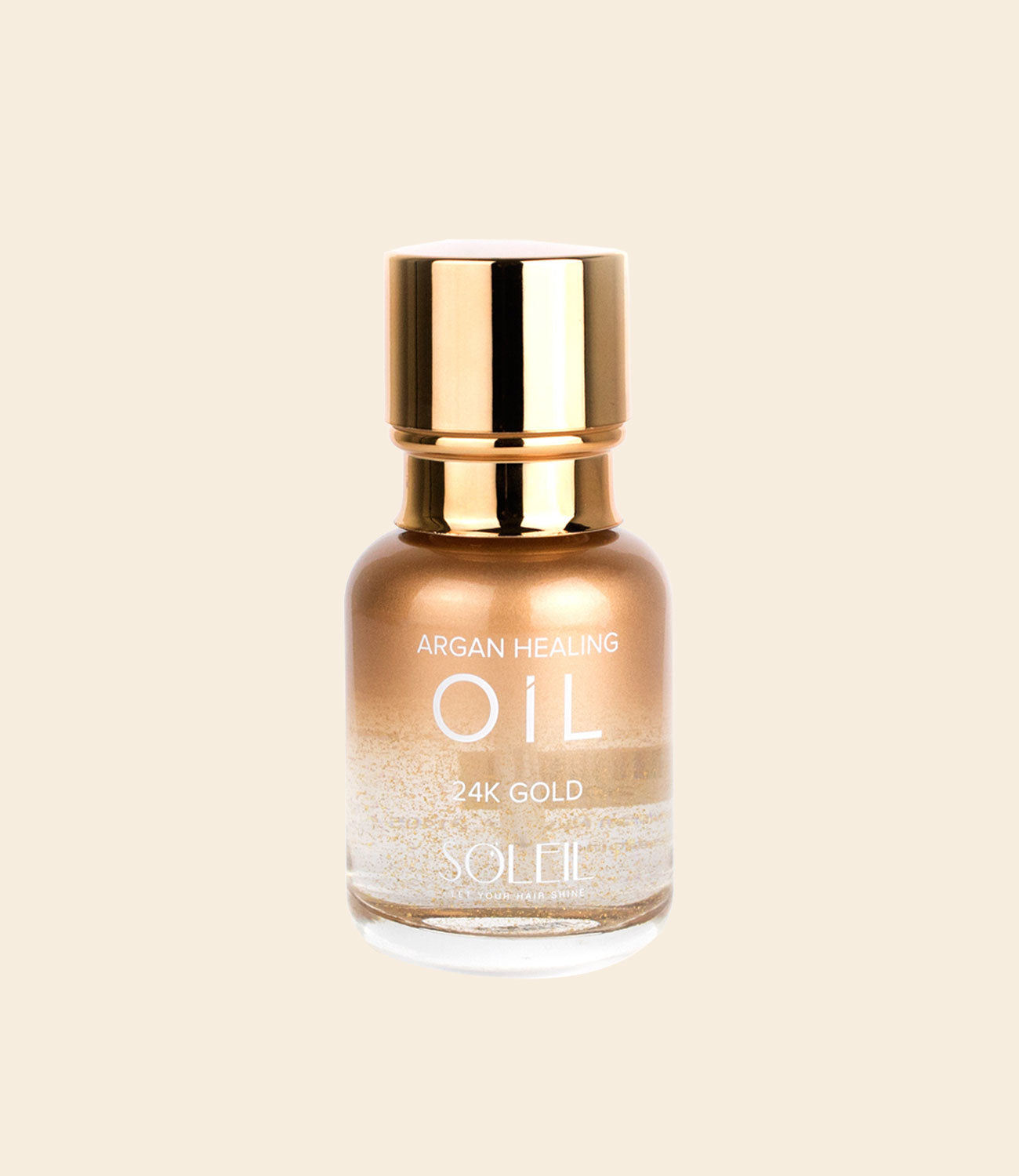 soleil argan healing oil 24k gold packaging with a gold lid anda glass half translucent and half rose gold gradient against light beige background